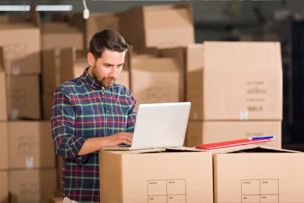 Businessman using store inventory management system in warehouse