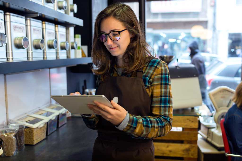 Saleswoman doing inventory in a retail coffee store