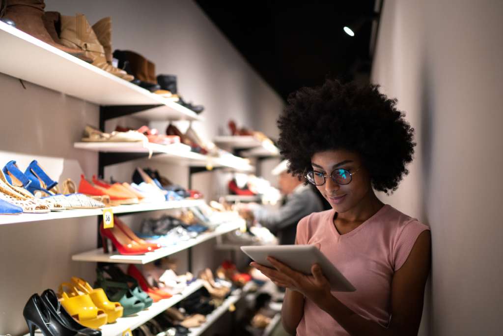 Woman checking inventory in shoe store